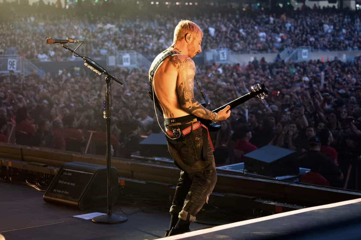 Avenged Sevenfold guitarist performing shirtless facing massive crowd
