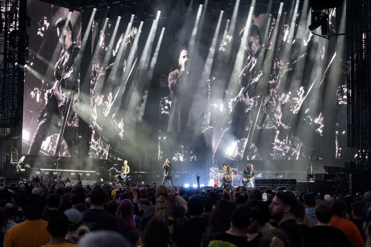Avenged Sevenfold performing on massive stage with LED screens and light beams